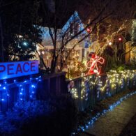 A view of Seattle’s Candy Cane Lane in the Ravenna neighborhood, glowing with holiday lights and decorated homes.