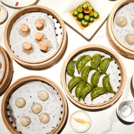 Overhead shot looking down at a table filled with various dim sum items.