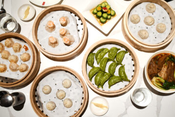 Overhead shot looking down at a table filled with various dim sum items.