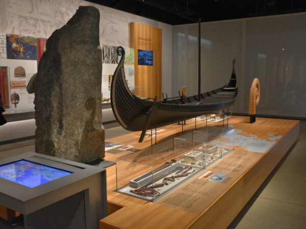 Interior shot of the National Nordic Museum, showing a historic Nordic boat on a wooden platform.