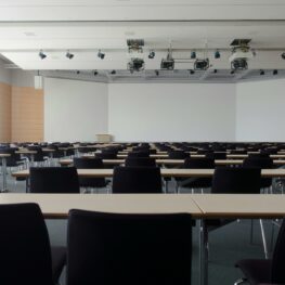 Empty chairs lined up in generic classroom