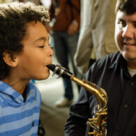 Child playing alto saxophone
