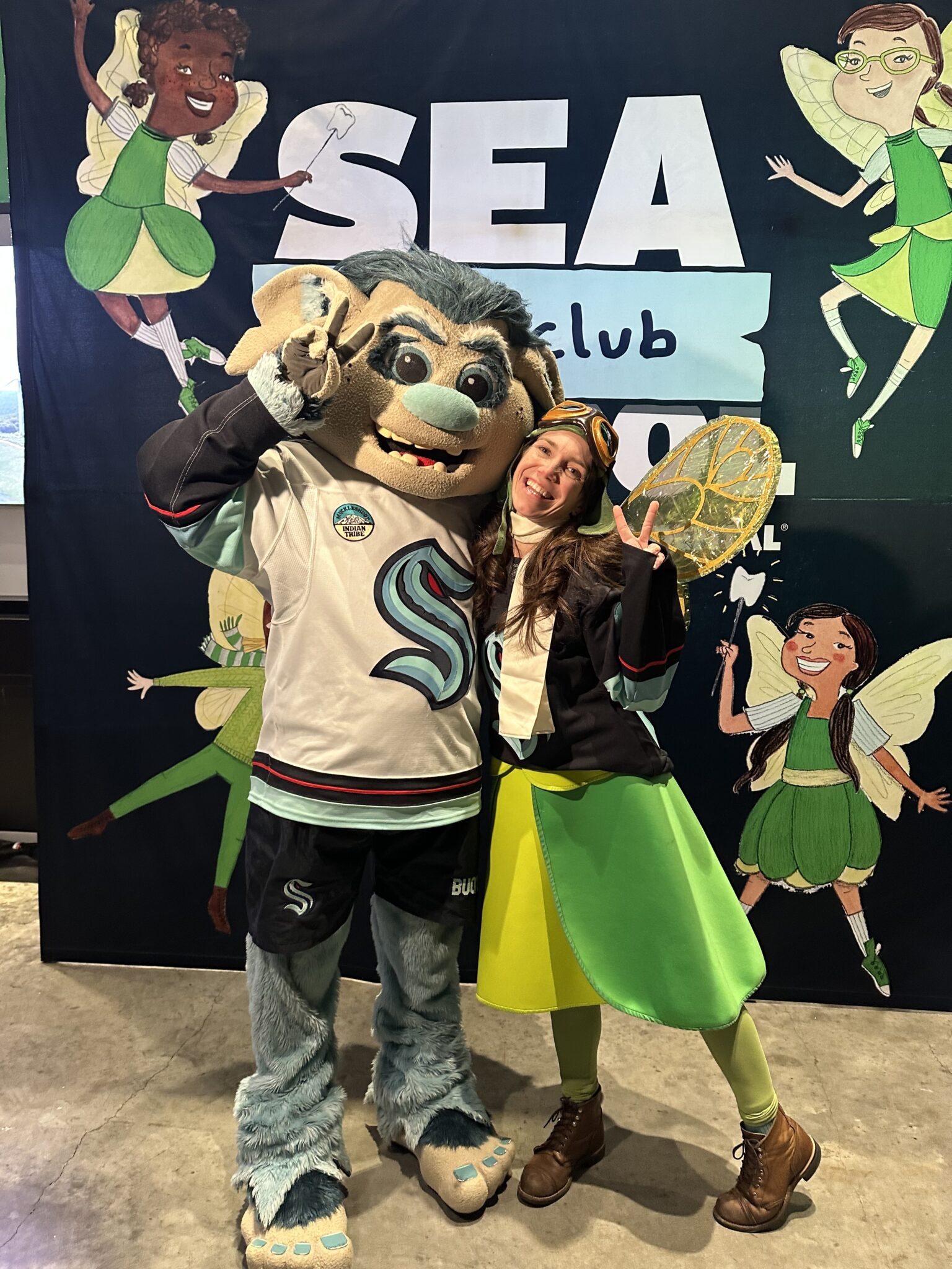 Buoy the Kraken mascot poses with the Tooth Fairy.