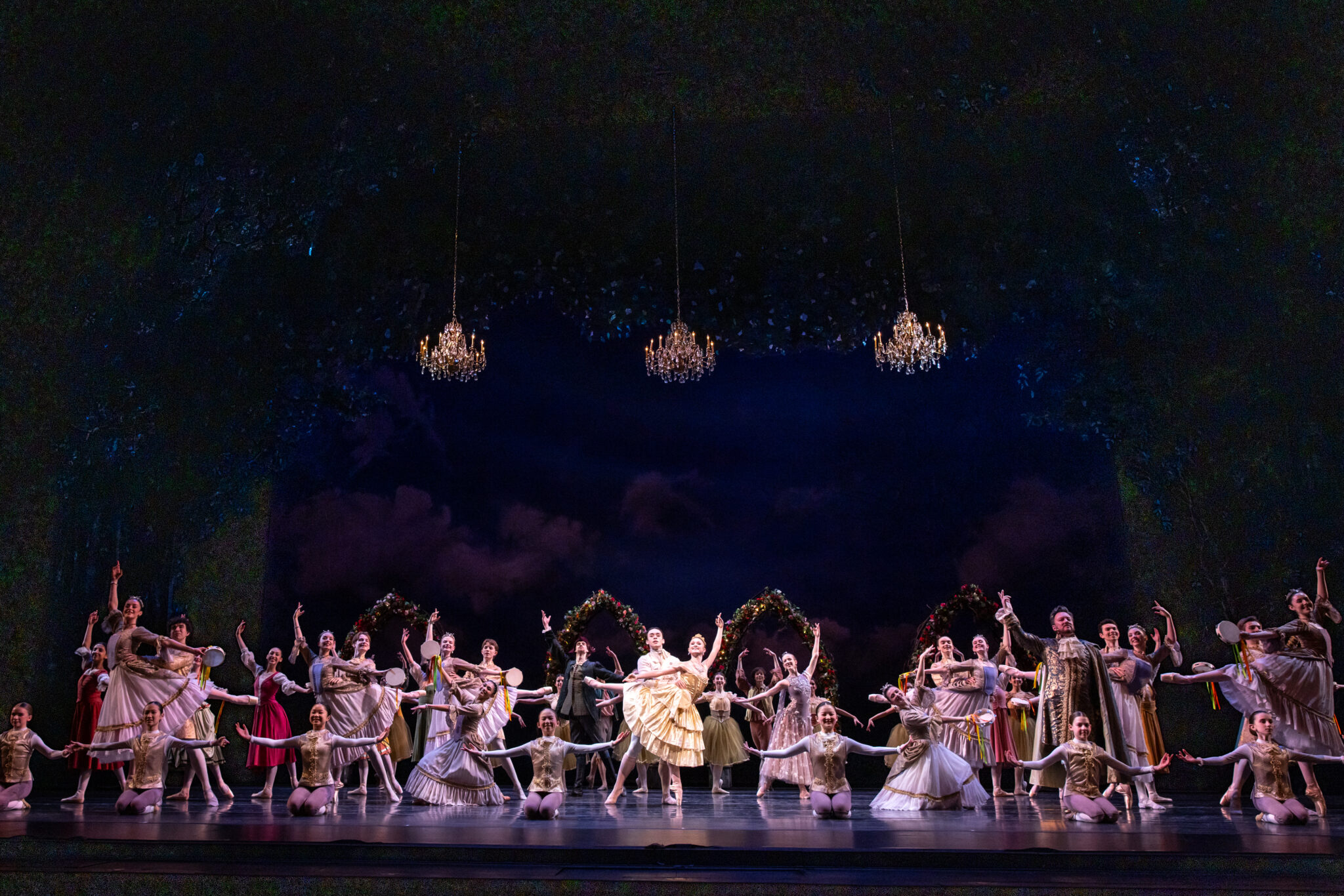 Entire company of dancers pose on stage