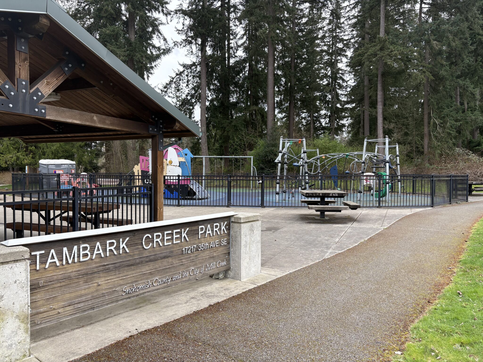 Covered area with sign in front that says Tambark Park