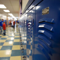 Empty school hallway lined with lockers, symbolizing the start of the school year.