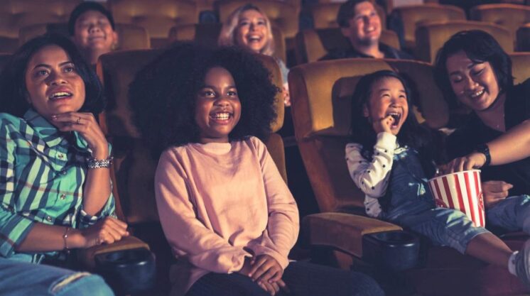 People kids watching movie in movie theater istock