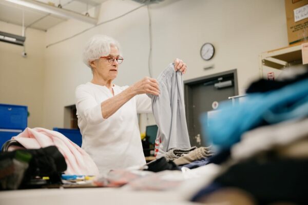 Volunteer sorts clothes at Treehouse Store for foster youth