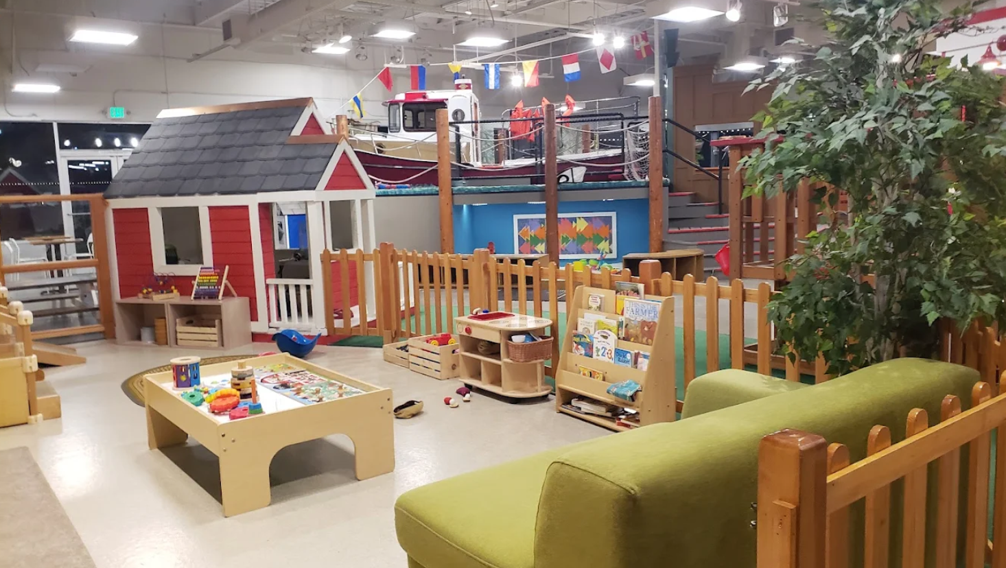 Main Street exhibits at the Children’s Museum of Skagit County in Burlington, featuring a tugboat, grocery store, and construction zone.