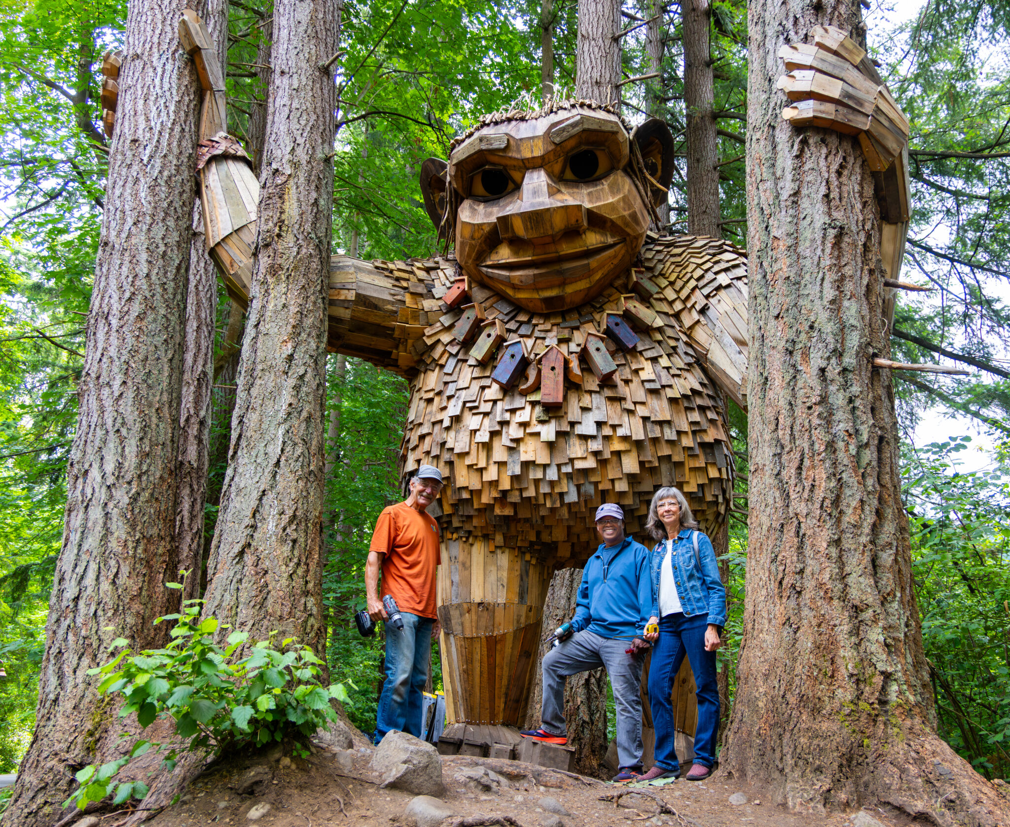 Seattle troll surrounded by volunteers