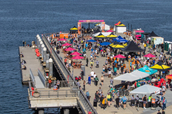 Aerial view of Seattle’s new 20-acre Waterfront Park filled with families enjoying the sunny grand opening celebration.