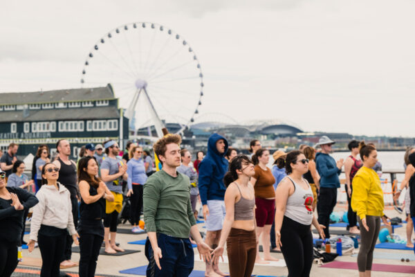 Families join outdoor yoga along Seattle’s new waterfront piers.