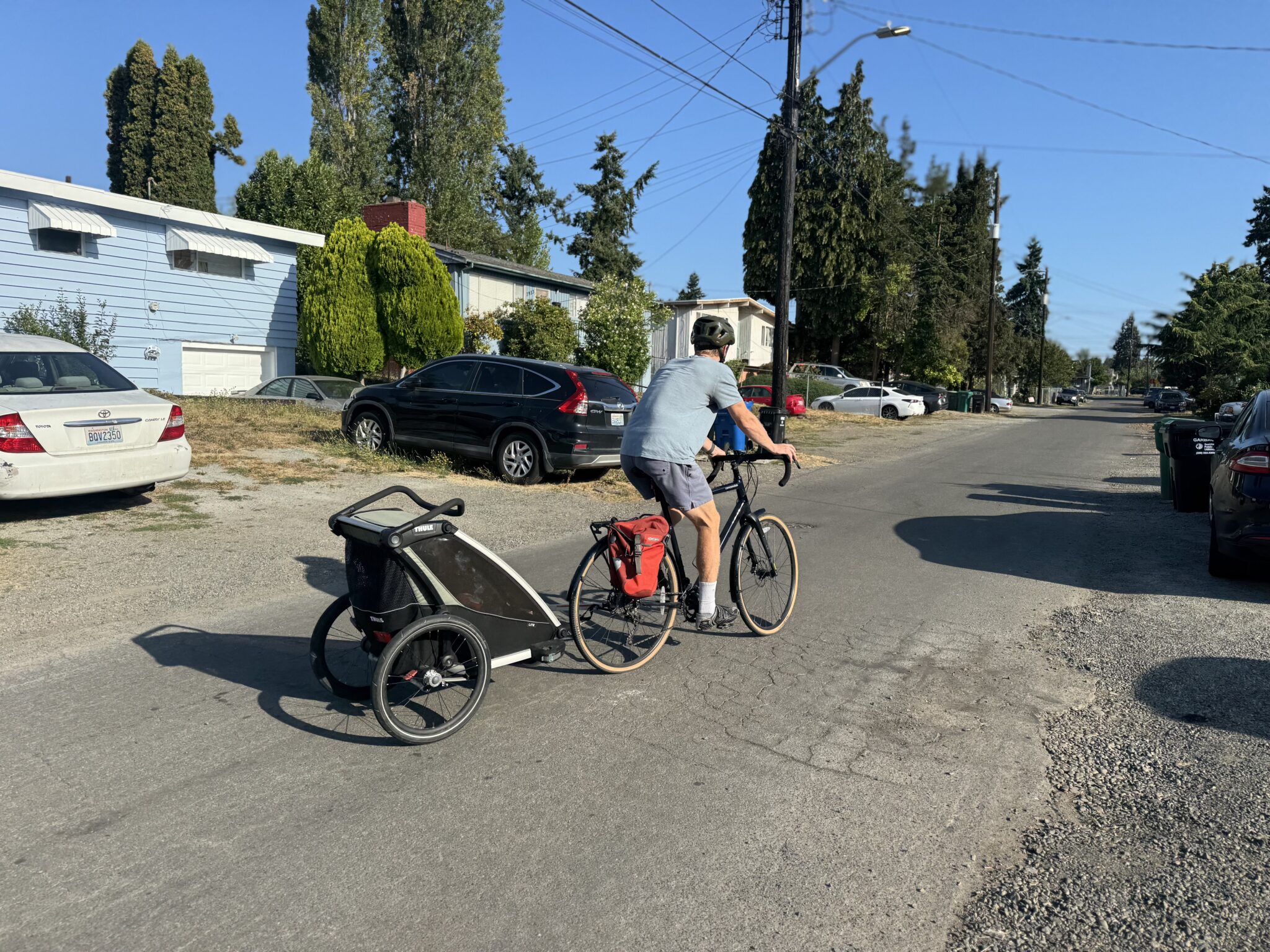 Dad bikes with child on the way to preschool.