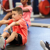 Students performing physical fitness test in school gymnasium