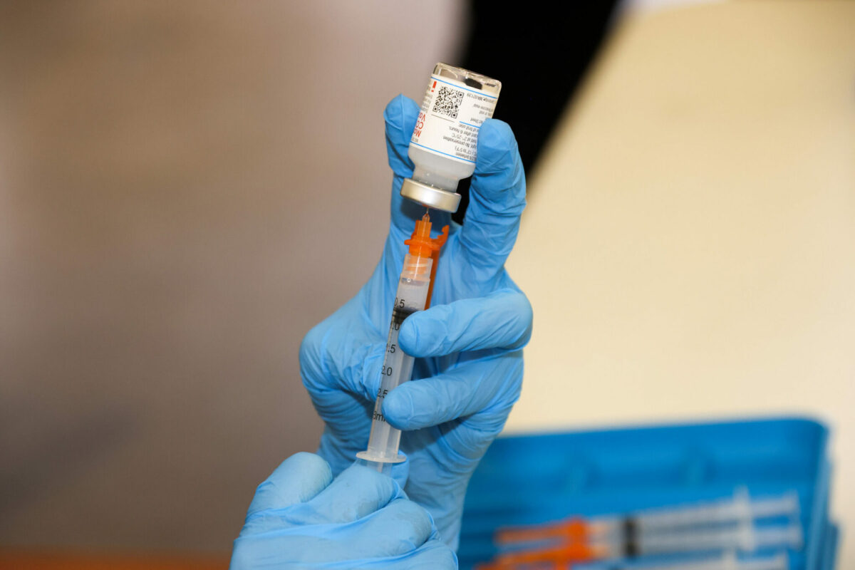 Pharmacist prepares a COVID-19 vaccine dose at a Washington clinic