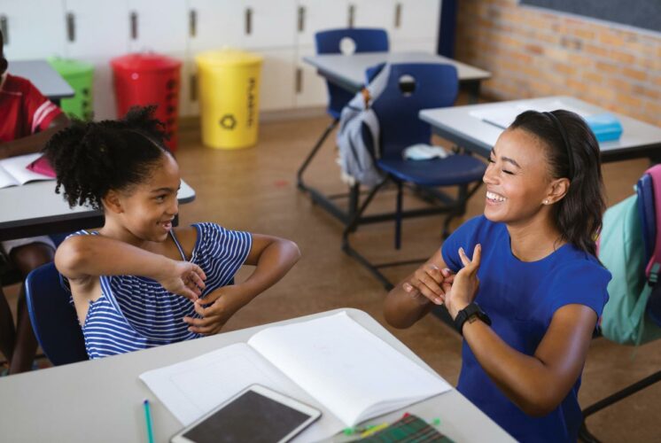 An ASL interpreter communicates with a student in a Seattle Public Schools classroom. Advocates say consistent, qualified interpreting is essential for DHH students to thrive.