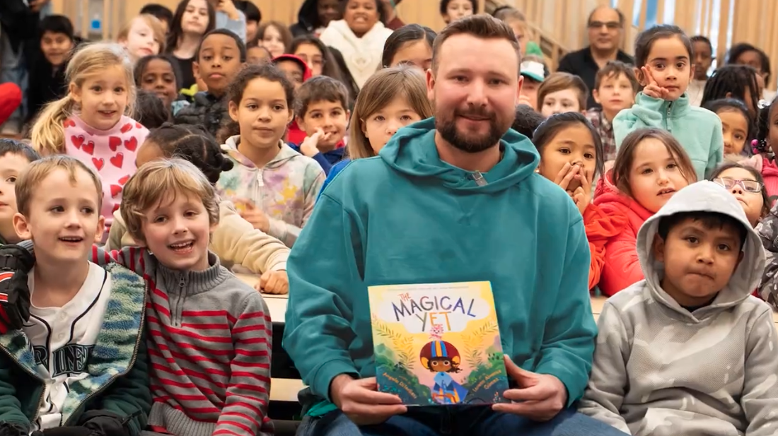Cal Raleigh Seattle Mariners catcher reading with kids as part of PEMCO Get Caught Reading challenge